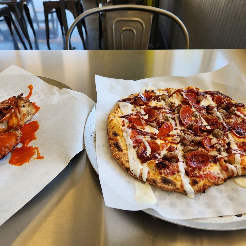 two pizzas on a table two pizzas on a table