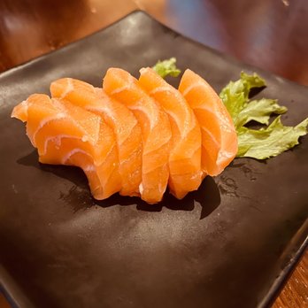 Kinkaku Izakaya - a close up of a piece of salmon on a black plate - Japanese Near Me - Kitchener, Ontario Kinkaku Izakaya - a close up of a piece of salmon on a black plate - Japanese Near Me - Kitchener, Ontario