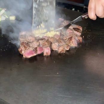 Fuji - a steak being cooked on a grill with smoke coming out of it - Sushi Bars Near Me - Torrington, Connecticut