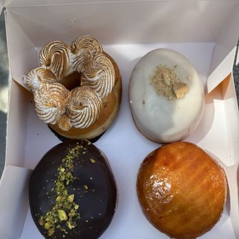 Doce Donut - Top left (tres leches, guava con queso) Bottom left (chocolate pistachio, Passion fruit crème brûlée) - Donuts Near Me - Bellevue, Washington Doce Donut - Top left (tres leches, guava con queso) Bottom left (chocolate pistachio, Passion fruit crème brûlée) - Donuts Near Me - Bellevue, Washington