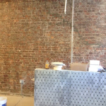 TPG Contracting - a room with a brick wall in the background - General Contractors Near Me - Long Island City, New York