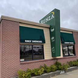 a brick building with a green awning