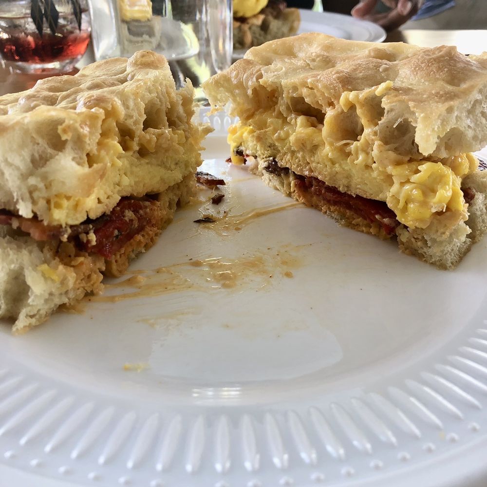 afternoon - Close up of egg and cheddar sandwich. Not pictured is my Mimosa! - New American Near Me - Gainesville, Florida