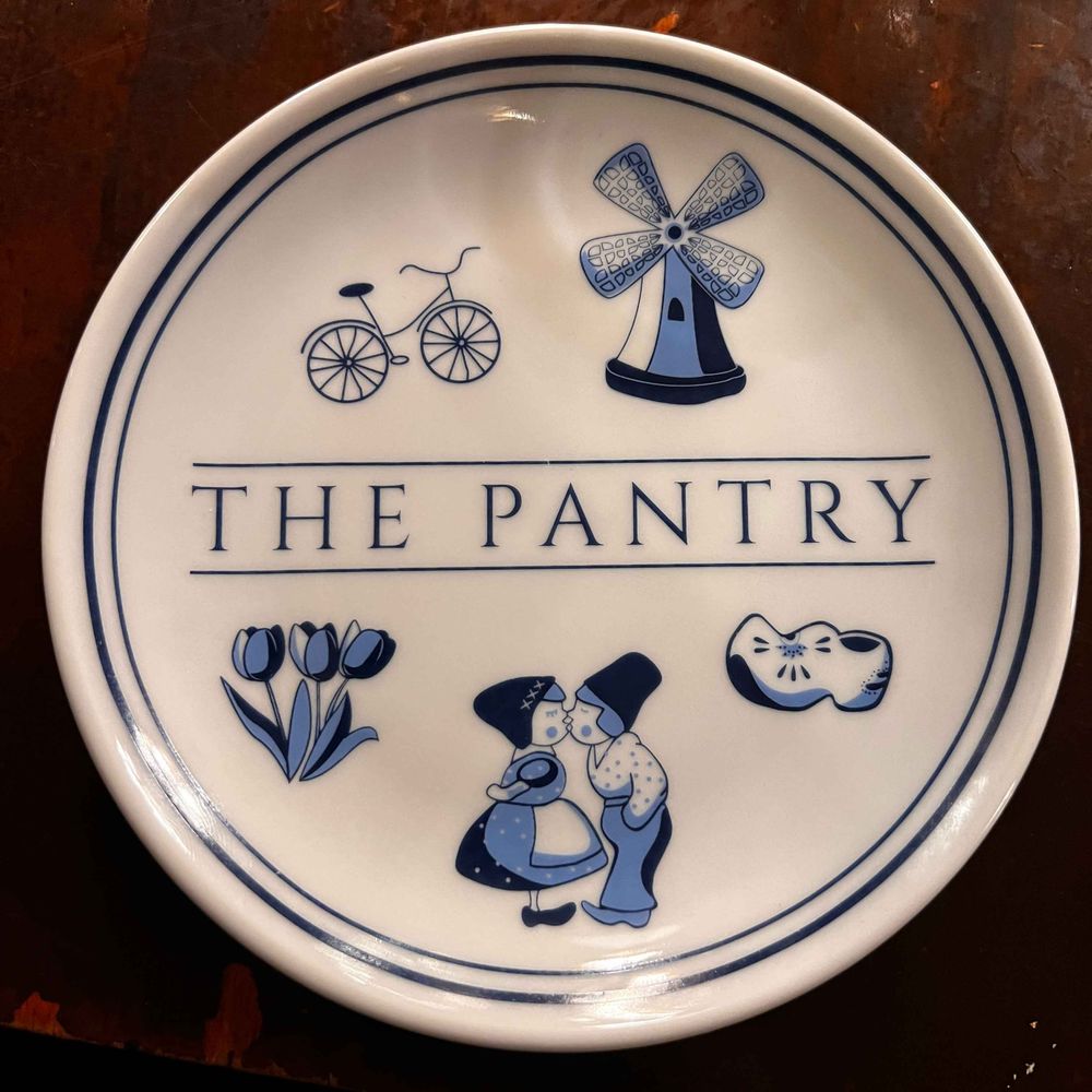 The Pantry plate with logo, windmill, bike, wooden shoes, tulips, couple The Pantry plate with logo, windmill, bike, wooden shoes, tulips, couple