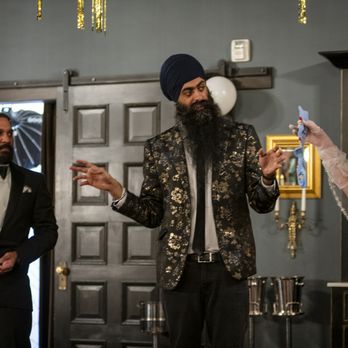 Amasingh Magic - A wedding reception scene with a man in a tuxedo holding a drink, a woman in a wedding dress holding a garter, and a man in a patterned jacket gesturing. - Magicians Near Me
