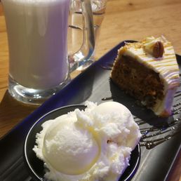 Carrot cake with ice cream and early grey tea latte. Asked for half sweet but seemed like pure sugar Carrot cake with ice cream and early grey tea latte. Asked for half sweet but seemed like pure sugar
