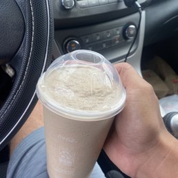 a hand holding a cup of coffee