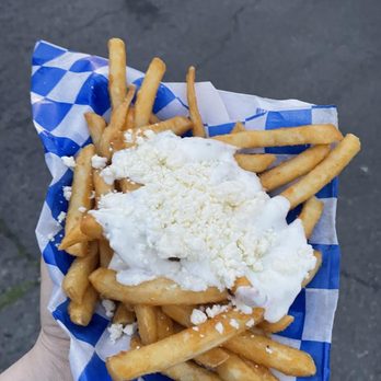 Eat Greek - a person holding a basket of cheese fries - Food Trucks Near Me - Rochester, New York Eat Greek - a person holding a basket of cheese fries - Food Trucks Near Me - Rochester, New York