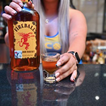 The Decoy - a woman holding a glass of alcohol - Venues & Event Spaces Near Me - Houston, Texas