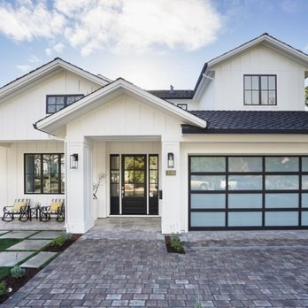 JBS Green Builders - a white house with a black garage door - General Contractors Near Me JBS Green Builders - a white house with a black garage door - General Contractors Near Me