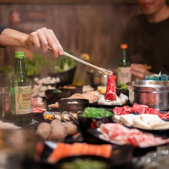 KPOT Korean BBQ & Hot Pot - a person cooking - Korean Near Me - Falls Church, Virginia KPOT Korean BBQ & Hot Pot - a person cooking - Korean Near Me - Falls Church, Virginia