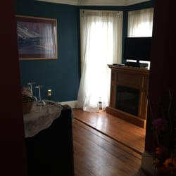 Turret sitting room (fridge, electric fireplace heater, tv, loveseat) in Autumn Suite
