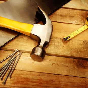 CNC Corporation - a hammer, saw, and nails on a wooden table - General Contractors Near Me - Olympia, Washington CNC Corporation - a hammer, saw, and nails on a wooden table - General Contractors Near Me - Olympia, Washington
