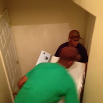 Adonis NYC Movers - Skillfully moving dryer down stairs through a narrow space and around the corner. - Movers Near Me Adonis NYC Movers - Skillfully moving dryer down stairs through a narrow space and around the corner. - Movers Near Me