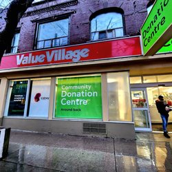 Value Village - Storefront at night and in rain
