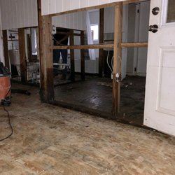 SGT HAUL - Removing paneling from a flooded house to allow the studs to dry and prevent mold