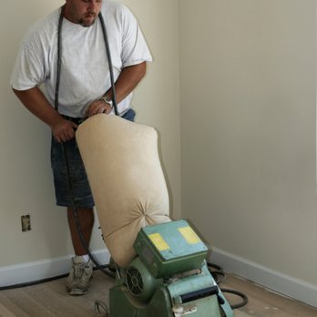 Top Notched Tile - a man using a machine - General Contractors Near Me Top Notched Tile - a man using a machine - General Contractors Near Me