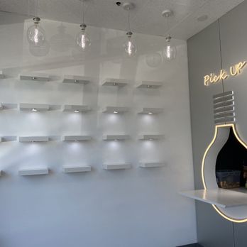Glow Tea - Covington - a white wall with shelves and hanging lights - Bubble Tea Near Me - Covington, Washington Glow Tea - Covington - a white wall with shelves and hanging lights - Bubble Tea Near Me - Covington, Washington