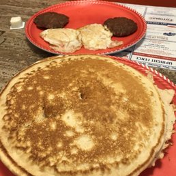 Pancakes eggs and patty sausage.