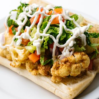 Veggitopia - a white plate with a sandwich on it - Vegan Near Me - Chicago, Illinois Veggitopia - a white plate with a sandwich on it - Vegan Near Me - Chicago, Illinois