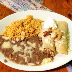 La Morenita - Shrimp enchiladas, with no sauce, only cheese and sour cream on top, per request. Rice and beans on side.