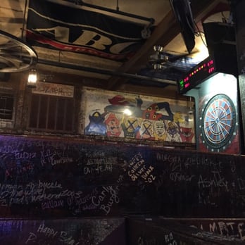 Wheel Pizza - a view of a bar with graffiti on the walls - Bars Near Me - Lawrence, Kansas