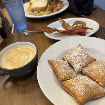 Fleur De Lis - Beignets, bacon, vanilla latte! My husband ordered a breakfast sandwich too. Food and service were awesome! - Breakfast & Brunch Near Me - New Orleans, Louisiana Fleur De Lis - Beignets, bacon, vanilla latte! My husband ordered a breakfast sandwich too. Food and service were awesome! - Breakfast & Brunch Near Me - New Orleans, Louisiana