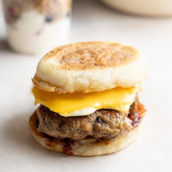 Kinship Café - Farmer's Favorite: house-made pork sausage, fried egg, American cheese, and tomato jam on an English muffin. Impossible Sausage available. - Coffee & Tea Near Me - Milwaukee, Wisconsin Kinship Café - Farmer's Favorite: house-made pork sausage, fried egg, American cheese, and tomato jam on an English muffin. Impossible Sausage available. - Coffee & Tea Near Me - Milwaukee, Wisconsin