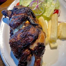 Half Peruvian chicken with yuca fries and a house salad Half Peruvian chicken with yuca fries and a house salad