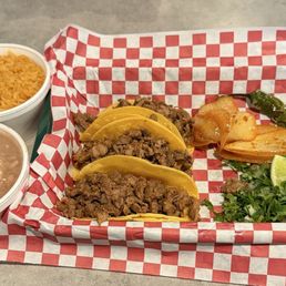 Street tacos with carne asada and a side of rice and beans. Street tacos with carne asada and a side of rice and beans.