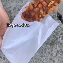 a person holding a piece of food a person holding a piece of food