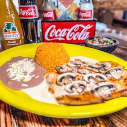 El Cazador Mexican Grill - Pollo Loco. Grilled chicken breast and mushrooms. Topped with Queso dip. Served with rice, beans , pico de gallo and tortillas.