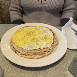 Scrambled Yolk - Pancake sandwich, two eggs and ham inside fluffy pancakes.