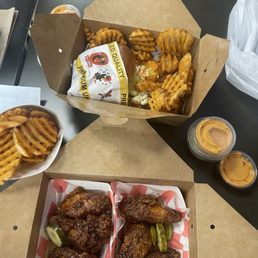 Spicy soy garlic wings waffle fries and a mega sando Spicy soy garlic wings waffle fries and a mega sando