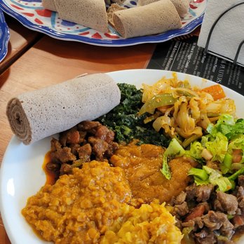 Dahlak Eritrean Restaurant & Bar - Injera (bread-like roll up) and vegetable and meat platter. - Italian Near Me - Saskatoon, Saskatchewan Dahlak Eritrean Restaurant & Bar - Injera (bread-like roll up) and vegetable and meat platter. - Italian Near Me - Saskatoon, Saskatchewan