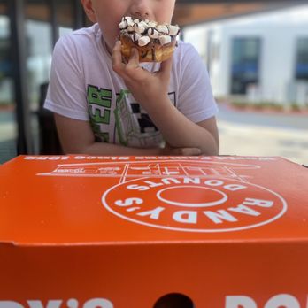 Randy's Donuts - a boy eating a doughnut - Donuts Near Me - Burbank, California Randy's Donuts - a boy eating a doughnut - Donuts Near Me - Burbank, California