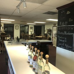 a long bar with bottles of wine on it