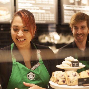 Starbucks - a woman holding a tray of pastries - Coffee & Tea Near Me - North Charlotte, North Carolina Starbucks - a woman holding a tray of pastries - Coffee & Tea Near Me - North Charlotte, North Carolina