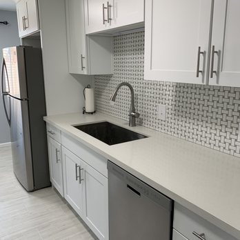 Alta Floors & Tile - a kitchen with white cabinets and white countertops - Flooring Near Me Alta Floors & Tile - a kitchen with white cabinets and white countertops - Flooring Near Me