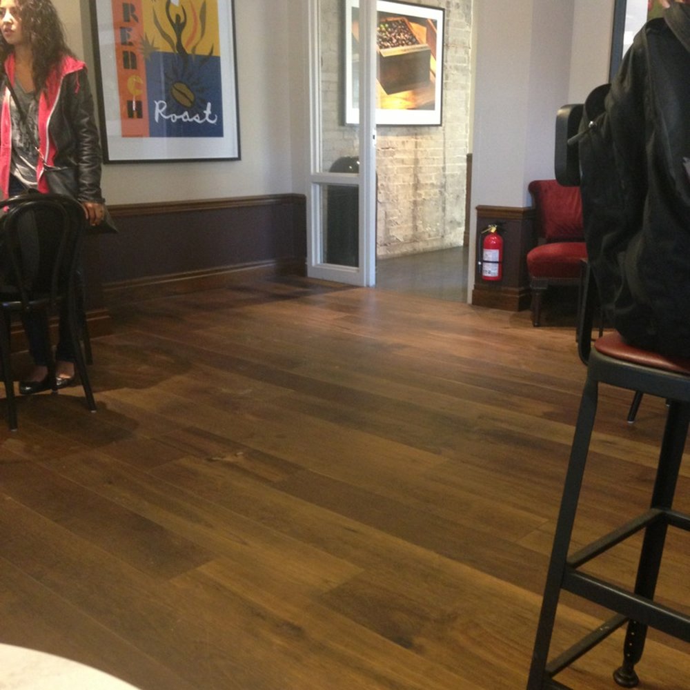 Starbucks - a woman sitting on a stool in a coffee shop - Coffee & Tea Near Me - Toronto, Ontario