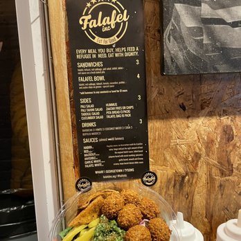 Falafel Inc - Falafel bowl in front of a menu - Falafel Near Me - Washington, DC, District of Columbia Falafel Inc - Falafel bowl in front of a menu - Falafel Near Me - Washington, DC, District of Columbia
