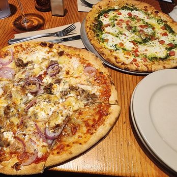 Flatbread Company - Kalua pork BBQ pizza on left and pesto Margarita on the right - Pizza Near Me - Portland, Maine