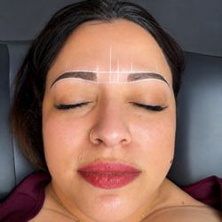 Shaping up her brow that she drew