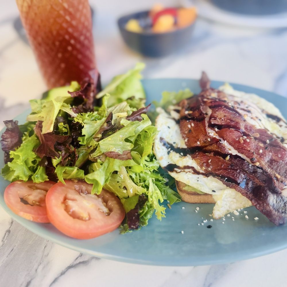 Haven Haus Cafe - Avocado Toast with an over easy egg and a side of bacon and an unsweetened peach iced tea - Breakfast & Brunch Near Me - Temecula, California Haven Haus Cafe - Avocado Toast with an over easy egg and a side of bacon and an unsweetened peach iced tea - Breakfast & Brunch Near Me - Temecula, California