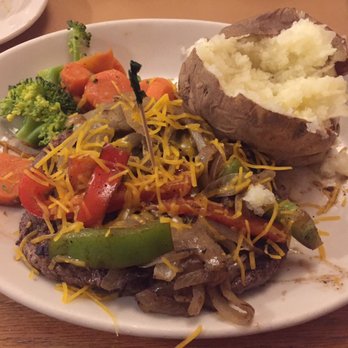 Maddox Ranch House - Bison patty covered in veggies. Baked potato and veggies on the side. - Steakhouses Near Me - Perry, Utah