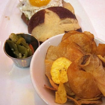 Carnivale Chicago - lunch sandwich--wagyu beef, sunnyside up egg on pretzel roll. accompanied with plantain and fresh bbq chips - Latin American Near Me - Chicago, Illinois Carnivale Chicago - lunch sandwich--wagyu beef, sunnyside up egg on pretzel roll. accompanied with plantain and fresh bbq chips - Latin American Near Me - Chicago, Illinois