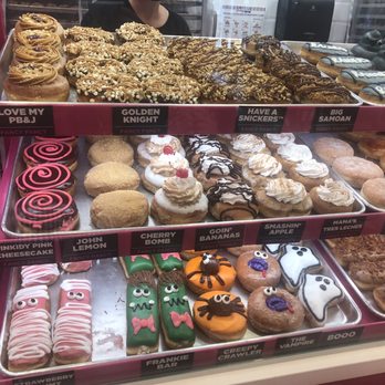 Pinkbox Doughnuts - More of the display case. Look t the cute Halloween designed donuts at the bottom. - Donuts Near Me - Primm, Nevada Pinkbox Doughnuts - More of the display case. Look t the cute Halloween designed donuts at the bottom. - Donuts Near Me - Primm, Nevada