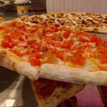 BKLYN Pizza - two slices of pizza on a pizza pan - Italian Near Me - Queens, New York BKLYN Pizza - two slices of pizza on a pizza pan - Italian Near Me - Queens, New York
