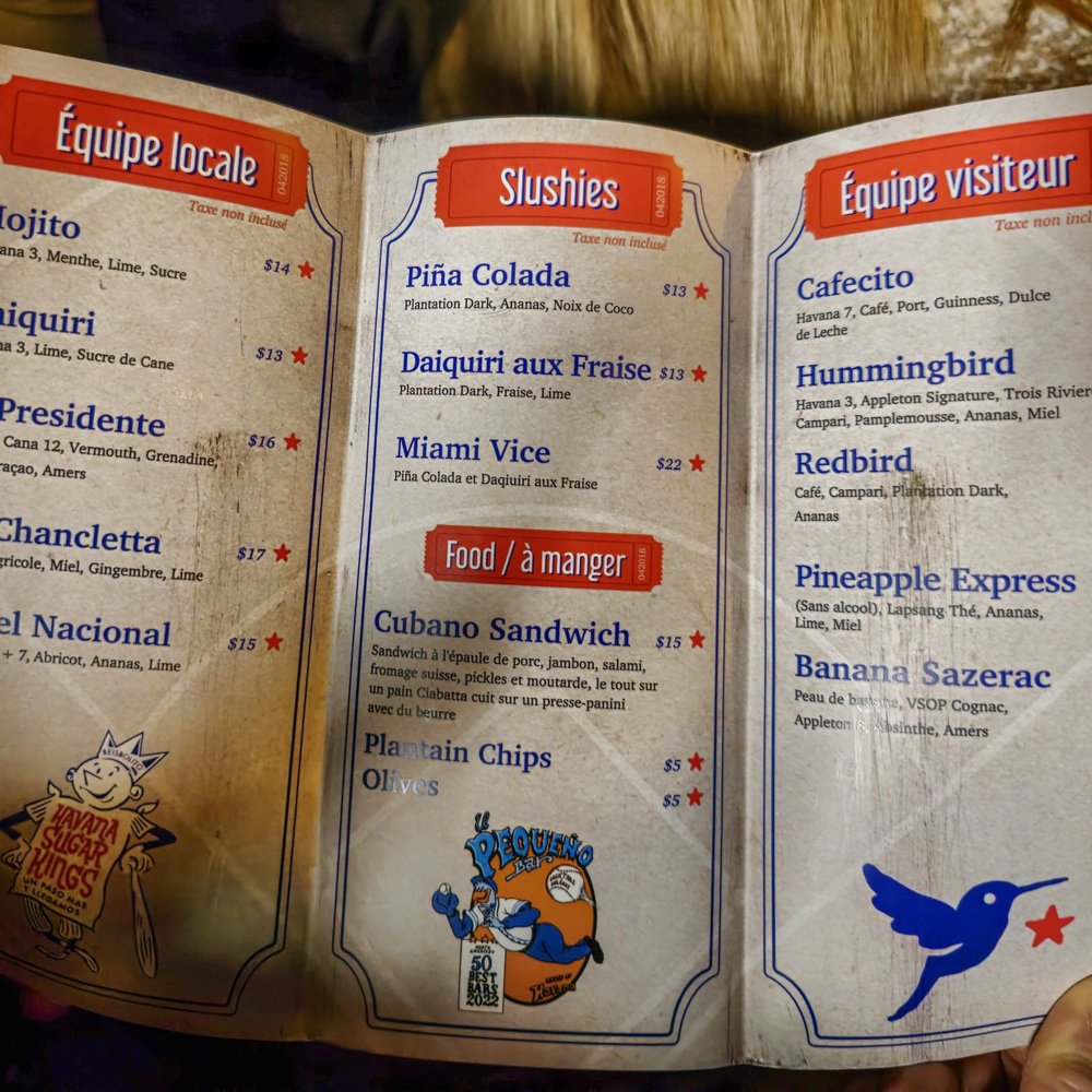 El Pequeño Bar - a person holding a menu - Cocktail Bars Near Me - Montreal, Quebec