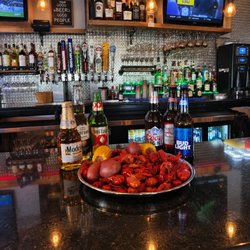 Red Crab Juicy Seafood - Cajun crawfish boil loaded with corn and red potatoes, served bar-side with ice-cold beer--bold, messy, and made to share.